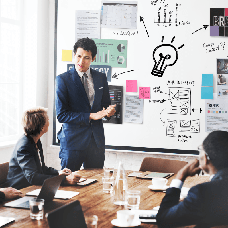 Entrepreneurship mentoring session with business planning on a whiteboard